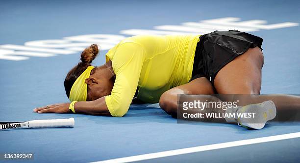 Serena Williams of the US lies on the court after injuring her ankle during her second round match against Bojana Jovanovski of Serbia at the...
