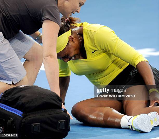 Serena Williams of the US receives treatment after injuring her ankle during her second round women's singles match against Bojana Jovanovski of...