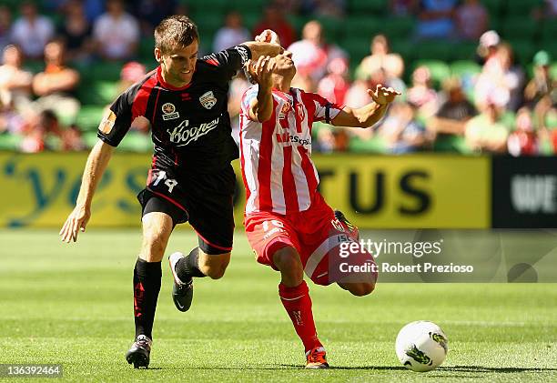 Cameron Watson of Adelaide and Aziz Behich of the Heart contest the ball during the round 13 midweek A-League match between the Melbourne Heart and...