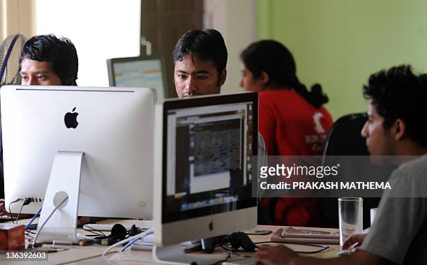 Cloud Factory staff working in their office in Kathmandu on September 28, 2011.The world's first "virtual factories" are creating workforces in the...