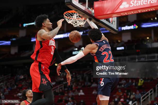 Matisse Thybulle of the Philadelphia 76ers dunks the ball in front of Christian Wood of the Houston Rockets in the second half at Toyota Center on...