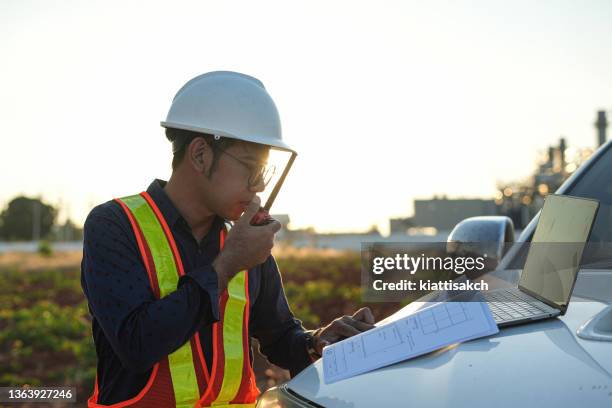 a male worker talking on walkie-talkie - walkie talkie stock pictures, royalty-free photos & images