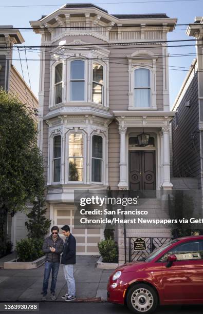 Sam Sumners, of Birmingham, Ala., and Cameron De La Huerta, right, of Ventura, Calif., look over photos they made at 1709 Broderick Street, the house...