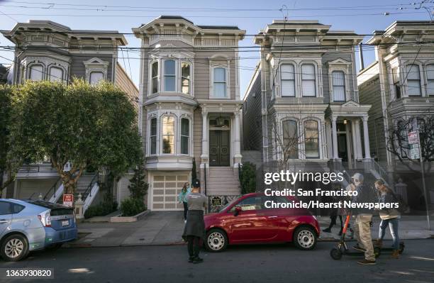 Fans gather to take photos at 1709 Broderick Street, the house depicted in the filming of the TV show, "Full House," after the sudden death of...