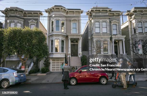 Fans gather to take photos at 1709 Broderick Street, the house depicted in the filming of the TV show, "Full House," after the sudden death of...