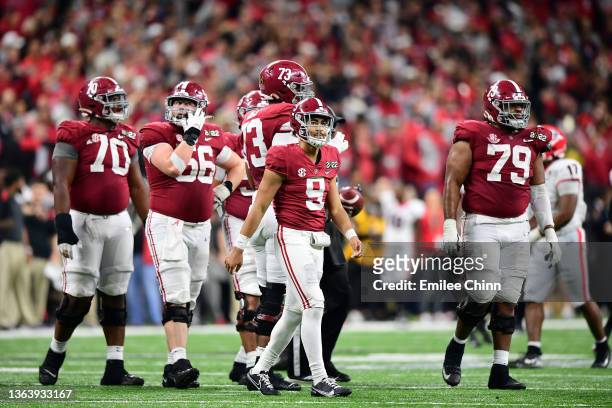 Bryce Young of the Alabama Crimson Tide looks on after being sacked in the fourth quarter of the game against the Georgia Bulldogs during the 2022...