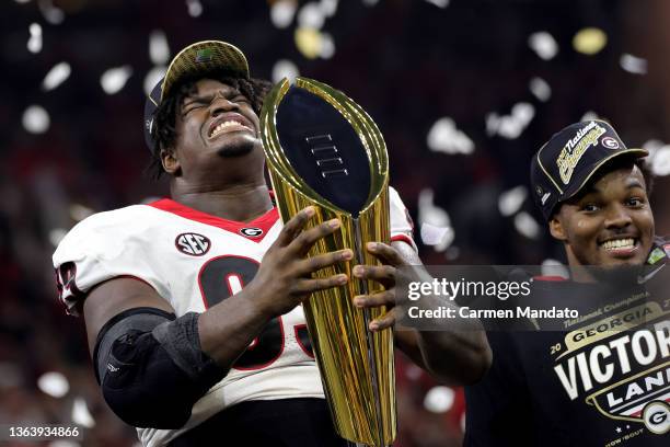 Jordan Davis of the Georgia Bulldogs celebrates with the National Championship trophy after the Georgia Bulldogs defeated the Alabama Crimson Tide...