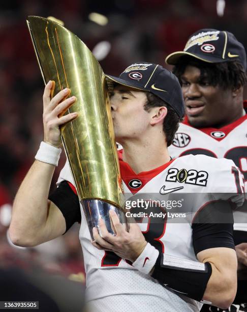 Stetson Bennett of the Georgia Bulldogs celebrates with the National Championship trophy after the Georgia Bulldogs defeated the Alabama Crimson Tide...