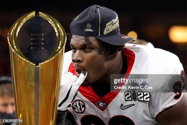 Jordan Davis of the Georgia Bulldogs celebrates with the National Championship trophy after the Georgia Bulldogs defeated the Alabama Crimson Tide...