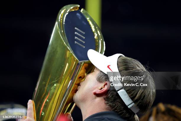 Head coach Kirby Smart of the Georgia Bulldogs kisses the National Championship trophy after the Georgia Bulldogs defeated the Alabama Crimson Tide...