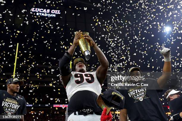 Jordan Davis of the Georgia Bulldogs celebrates with the National Championship trophy after the Georgia Bulldogs defeated the Alabama Crimson Tide...