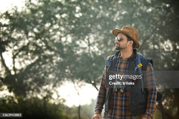 male hiker admiring nature in forest - binocular with man stock pictures, royalty-free photos & images