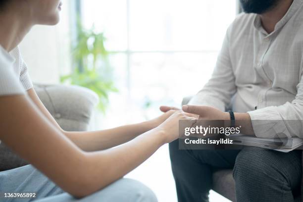 psychologist is listening to problems of a woman patient - psychiatric hospital stock pictures, royalty-free photos & images