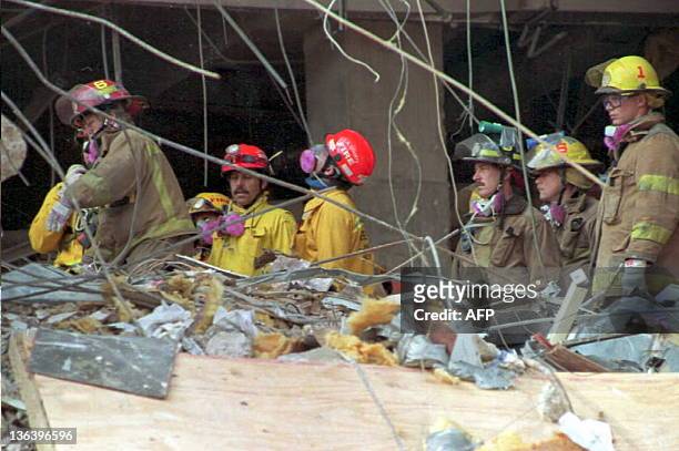 Emergency workers sift through the rubble of the Alfred P. Murrah Federal Building in downtown Oklahoma City, OK, 24 April, as searching for victims...