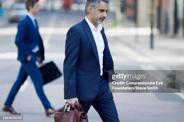 businessman walking in city - man side way looking stock pictures, royalty-free photos & images