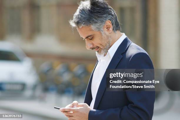 businessman using smart phone in city - smith street stock pictures, royalty-free photos & images