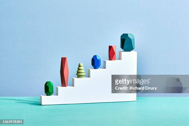 conceptual image of geometric pebbles - hierarchie stock-fotos und bilder