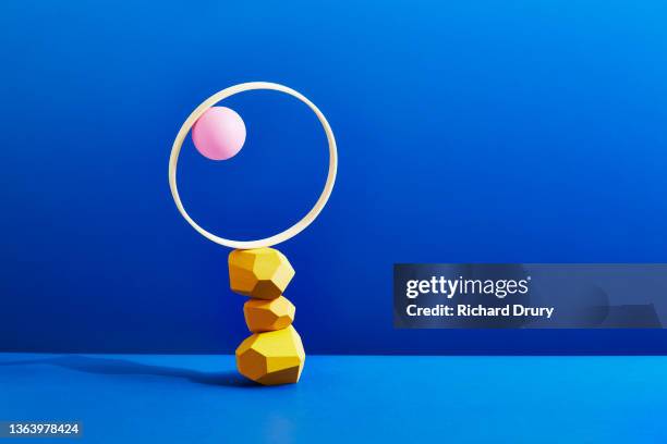 conceptual image of geometric pebbles - coordinated effort stock pictures, royalty-free photos & images