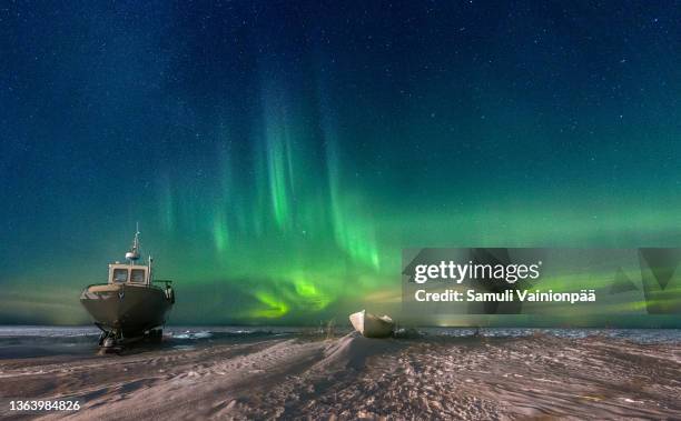 fishing and rowboat under the sky during northern lights, hailuoto, finland - oulu finland stock pictures, royalty-free photos & images