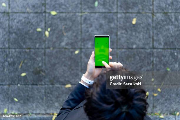 asian man using smart phone. - iphone hand green screen stock pictures, royalty-free photos & images