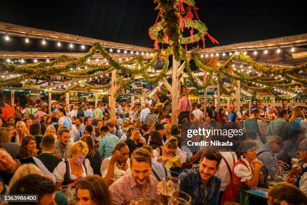 visitors celebrating, oktoberfest in munich, germany - biergarten münchen stock pictures, royalty-free photos & images