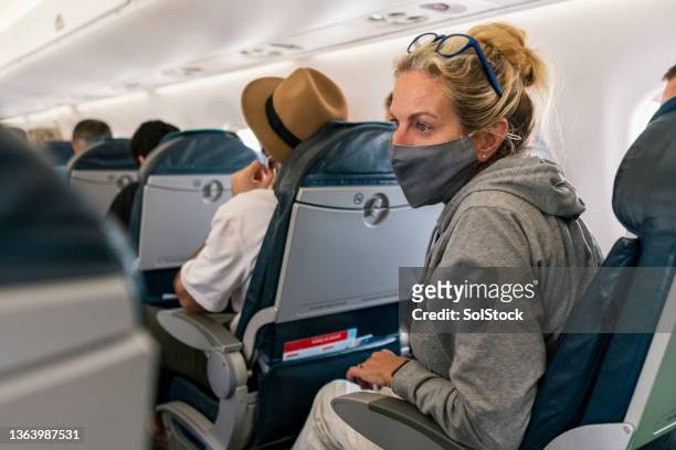 travelling by airplane - plane passenger stock pictures, royalty-free photos & images