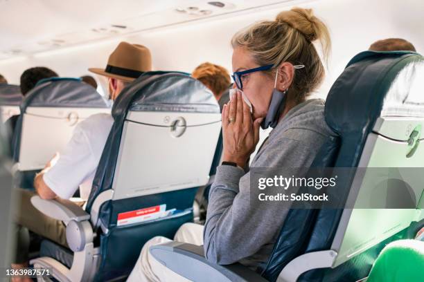 feeling sick on an airplane - illness stockfoto's en -beelden