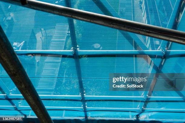 view through scaffolding & safety net - safety net stock pictures, royalty-free photos & images