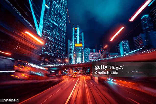 blurred motion speed light tail with night city background - hong kong high speed train stock pictures, royalty-free photos & images