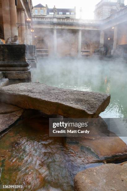 Mist rises from the naturally warmed water in the historic Roman Baths on March 1, 2019 in Bath, England. Bath, a popular destination for tourists,...