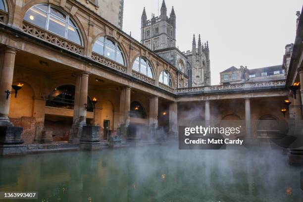 Mist rises from the naturally warmed water in the historic Roman Baths on March 1, 2019 in Bath, England. Bath, a popular destination for tourists,...