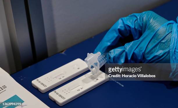 Health technician drops liquid into a test stick during a test in the antigen test facility set up at Palacio dos Congressos by Cascais Municipality...