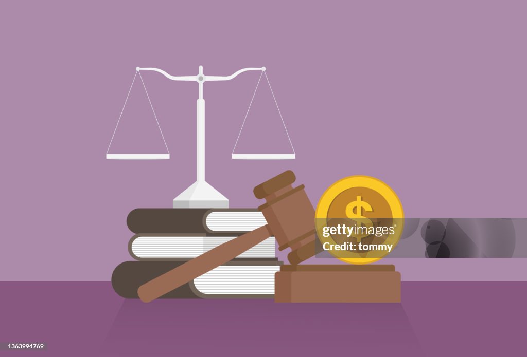 Equal-arm balance, a book, a gavel, and a US dollar coin on a table
