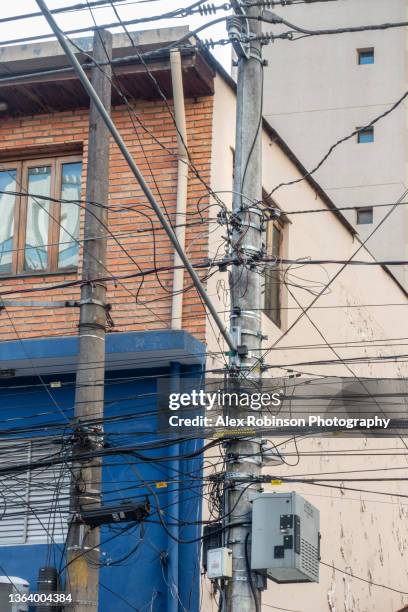 untidy electricity cables and junction boxes on a concrete post - street light post stock pictures, royalty-free photos & images
