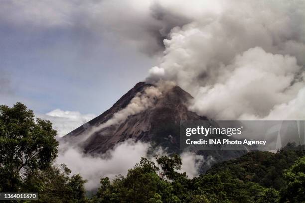 Mount Merapi, Indonesias most active volcano spews ash and smoke from its peak as seen from Kali Boyong, in Sleman, Indonesia on December 25, 2021....