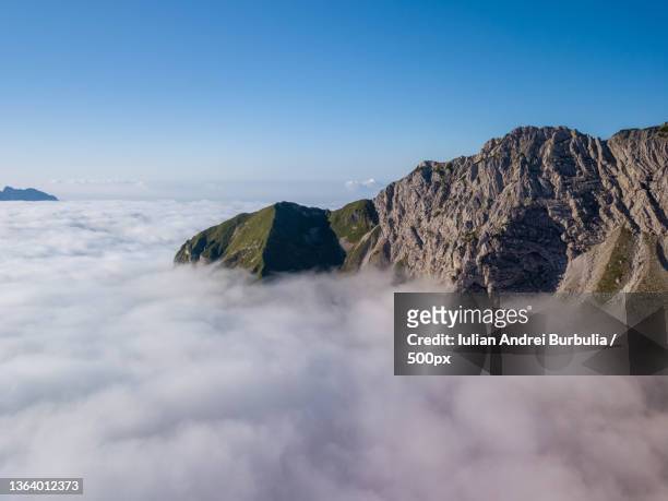 above the cloud,scenic view of mountains against clear blue sky,via caltene,cesiomaggiore,belluno,italy - iulian andrei stock-fotos und bilder