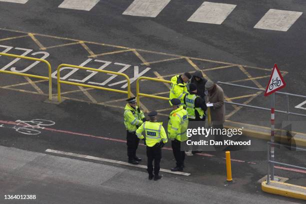 Kent Police officers question two men after finding them in the back of a lorry queuing to enter Dover port to board a ferry to mainland Europe on...