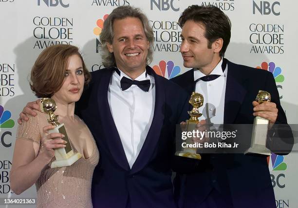 Files Chris Carter joins cast members Gillian Anderson and David Duchovny backstage at Golden Globe Awards Show, January 19, 1997 in Beverly Hills,...