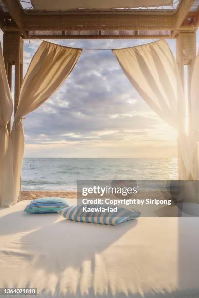 seaside cabana with two pillows at sunset - beach hut stock pictures, royalty-free photos & images