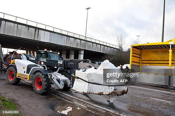 Picture taken on January 4, 2012 shows a vehicle carrying marchandise after a lorry drove off a bridge on the E25 highway and crashed into the N678...