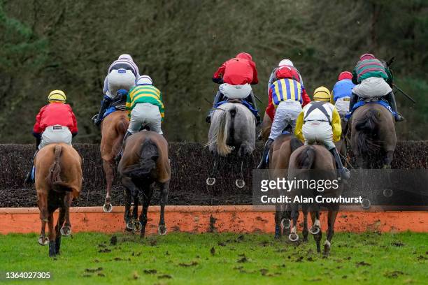 Runners clear a fence during The Timeform Premium Ratings Available At racingtv.com Handicap Chase at Exeter Racecourse on January 11, 2022 in...