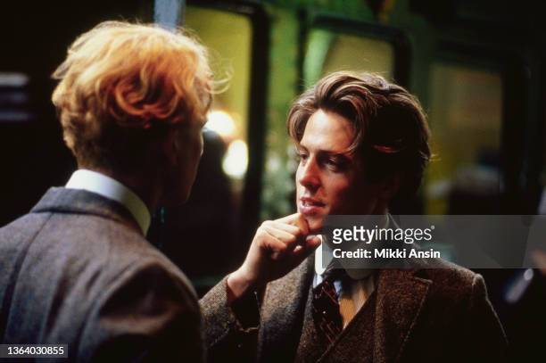British actors James Wilby and Hugh Grant talk together during the filming of 'Maurice' , London, England, December 1986.