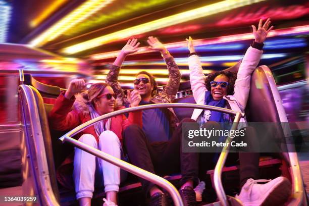 young adults on fairground ride - amusement ride stock pictures, royalty-free photos & images