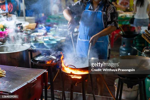 street restaurant in an alley adjacent to yaowarat road, chinatown. - bangkok street stock pictures, royalty-free photos & images