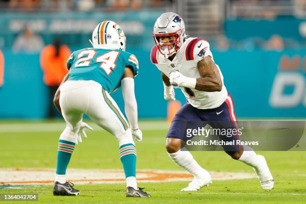 Keal Harry of the New England Patriots is defended by Byron Jones of the Miami Dolphins at Hard Rock Stadium on January 09, 2022 in Miami Gardens,...
