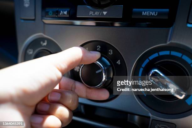 hand of woman turning on car air condition system,button on dashboard in car panel,auto car air condition - central air conditioner stock pictures, royalty-free photos & images