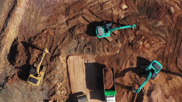 https://media.gettyimages.com/id/1364050973/video/construction-site-aerial-top-view-road-roller-and-loader-excavator-tractor-and-soil-grade-car.jpg?b=1&s=640x640&k=20&c=zh07V7UzFQhA_6IW-NvGEuZP1JIASE7dvAD-qqGHtsM=