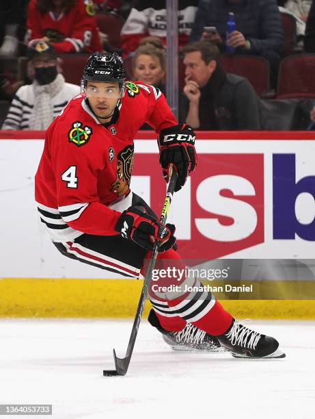 Seth Jones of the Chicago Blackhawks turns with the puck against the Nashville Predators at the United Center on December 17, 2021 in Chicago,...