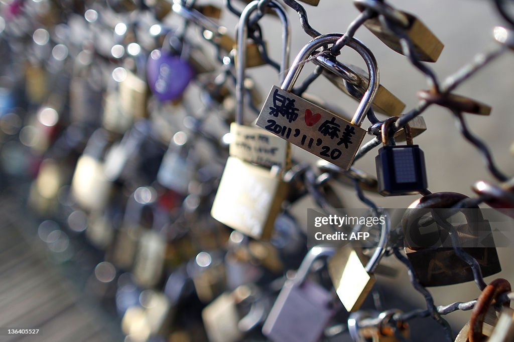 Love padlocks attached to a fence by lov