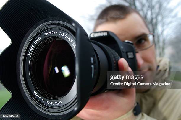 Close up detail of a photographer with a Sigma 18-200mm f/3.5-6.3 DC lens on a Canon camera, taken on December 20, 2006.